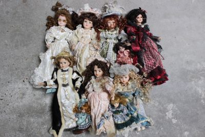 a lot of dolls that are sitting on the floor