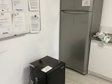 a refrigerator and a refrigerator freezer in a small room