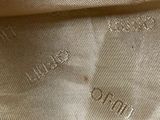 the fabric is tan and white with a small pattern on it