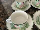 four cups and saucers are sitting on a counter top