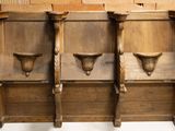 three wooden benches sitting next to each other in a room