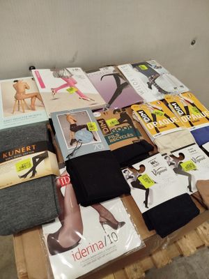 a table that has a lot of clothing and magazines on it