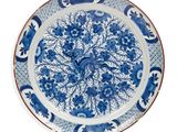 a blue and white plate with a floral design on it