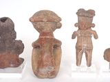 several pieces of pottery sitting on top of a white surface