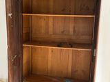 a wooden cabinet with a door open on a hard wood floor