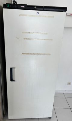 a white refrigerator in the corner of a kitchen