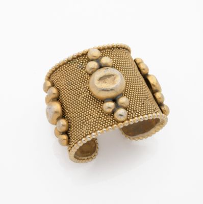 an image of a gold cuff bracelet with beads on it