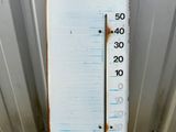 a thermometer that is on the side of a building