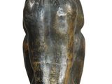 a bronze statue of a woman sitting on a chair