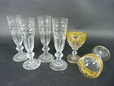 six glass goblets and four wine glasses on a table