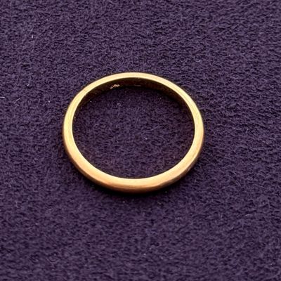 a gold ring on a purple surface