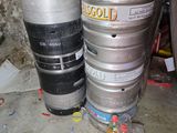 two kegs sitting next to each other on the floor