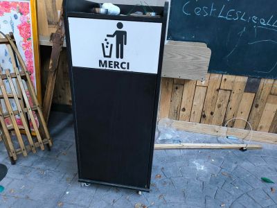 Une poubelle en stratifié noir sur roulettes