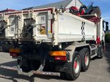 a white dump truck parked in a parking lot