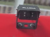 a small camera attached to the side of a red car