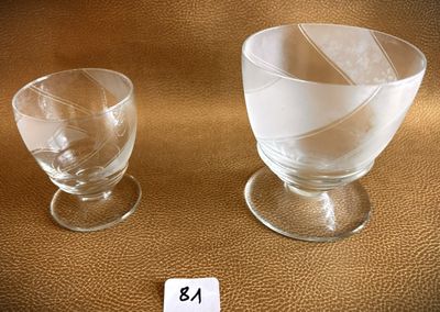 two empty wine glasses sitting next to each other on a table
