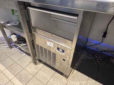 a metal counter top with a refrigerator and a freezer on it