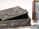 a small box that is sitting next to a picture frame