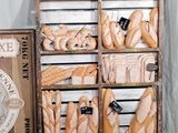 many different types of bread displayed in a display case