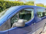 a blue van that is parked on the side of the road