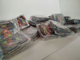 many bags of comics sitting on a table