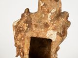 sculpture of a woman holding a child on her back in a cave