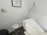 a room with a bed and a chair in it