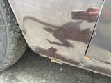 a close up of a car ' s tire with a shadow of a cat on it