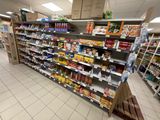 many shelves in the store that have various foods on them