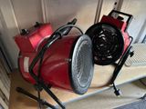 a red blower sitting on top of a wooden shelf