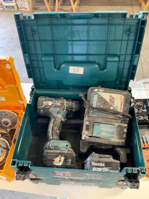 a green tool box with tools in it on a table