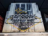 a neon sign on the side of a building with a bicycle on it