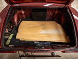 a red car with a yellow box in the trunk