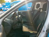 the interior of a car with the door open and the driver ' s seat up