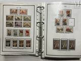an open book with stamps on it on a table