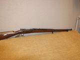 le fusil est posé sur la table près du mur