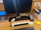 a computer desk with a keyboard and a monitor on it