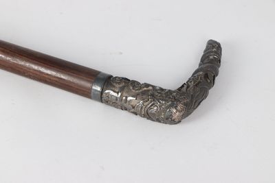 an old pipe with a wooden handle on a white surface