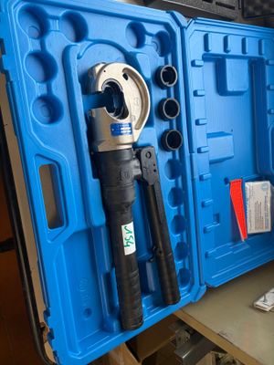 a blue tool case with tools in it on a table