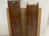 two wooden cabinets in the corner of a room