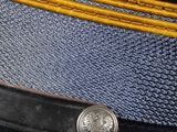 a close up of a uniform hat with a gold buckle
