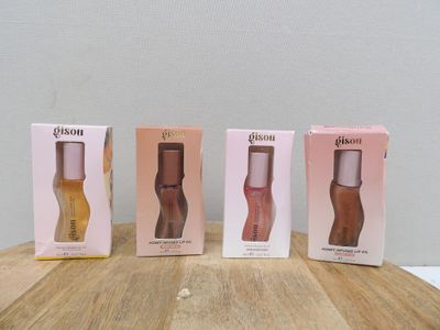 three boxes of perfume sitting on top of a wooden table