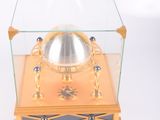 a glass display case with a clock inside of it