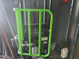 a green gate in the middle of a room next to a fire hydrant
