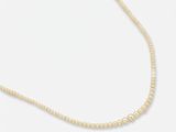 a white pearl necklace with a gold clasp on a white background