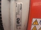 a close up of a red and white machine with a sticker on it