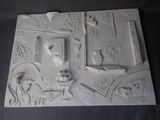 a relief of a horse drawn carriage with people in it