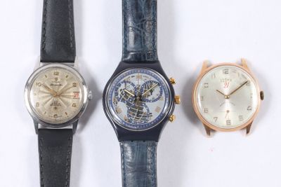 three different watches sitting next to each other on a white surface