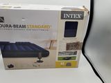 the box of the inflatable mattress is open on the table