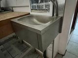 a sink in the corner of a room with a window